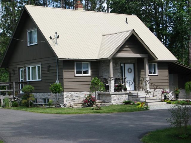 Home addition with stone accents and metal roof